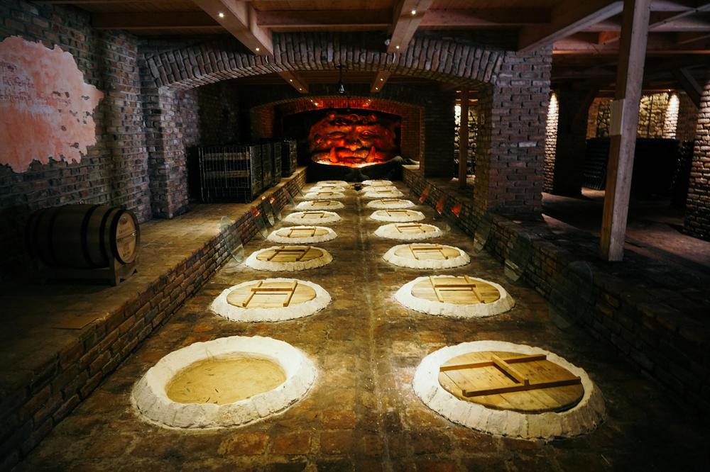 Traditional Georgian qvevri clay amphora vessels at Shumi Winery's underground cellar